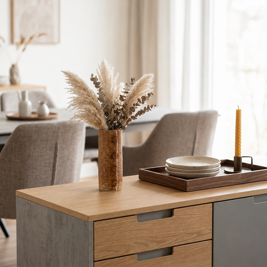 button vase with pampas on sideboard