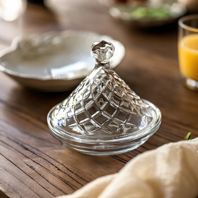 cake plate with conical lid on the wooden dining table