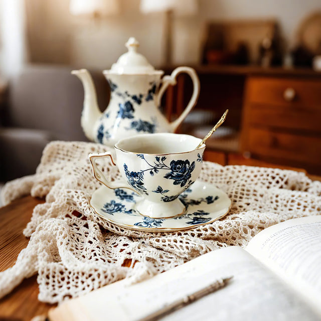 ceramic floral tea set on hollowed out tablecloth