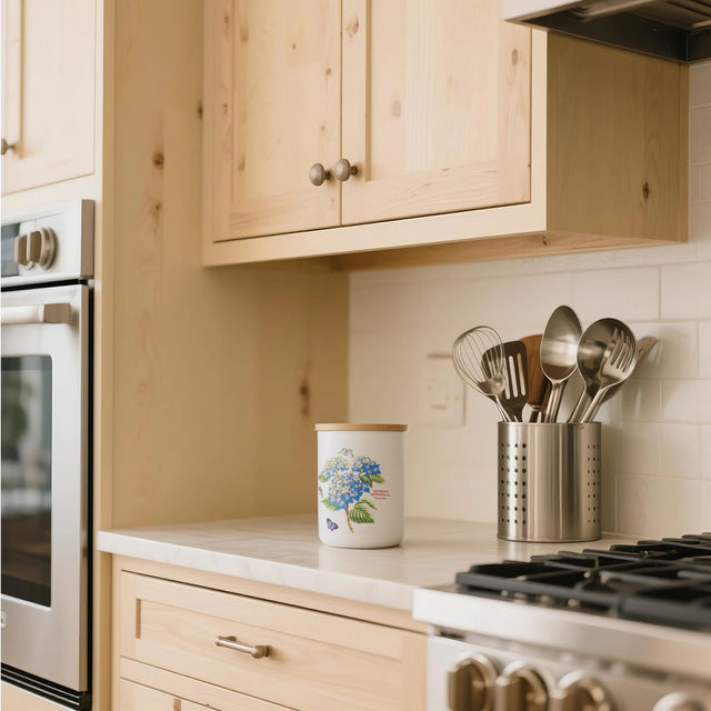 ceramic white cylinder storage jar with a wooden lid in the kitchen