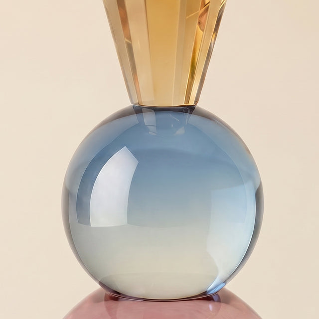 close up of blue glass sphere on candle holder