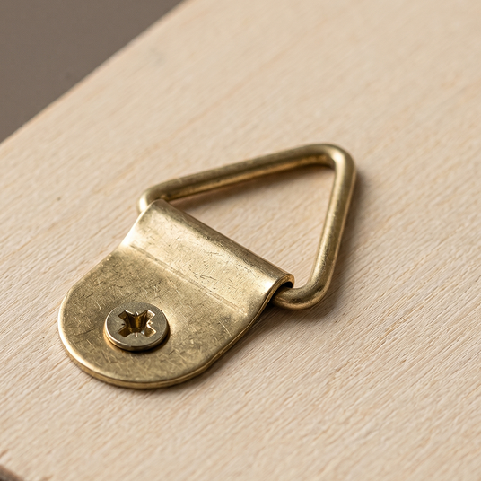 close up of brass wall hanging ring on wood