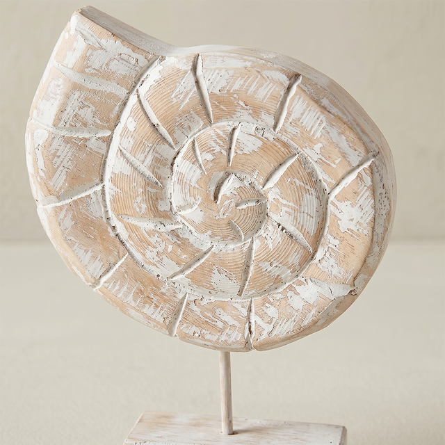 close up of distressed wood seashell figurine