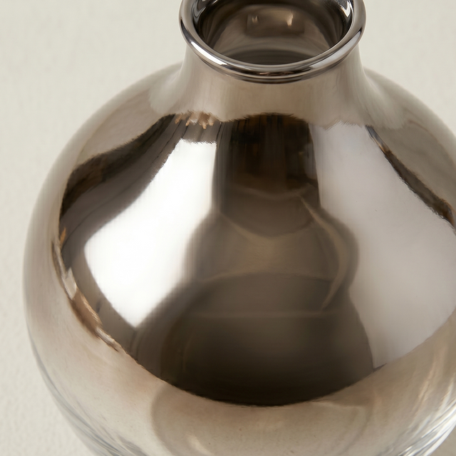 close up of grey ombre glass vase surface