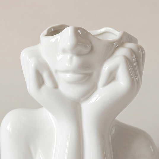 close up of white ceramic face vase face
