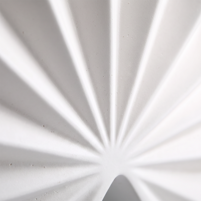 close up of white pleated vase surface texture