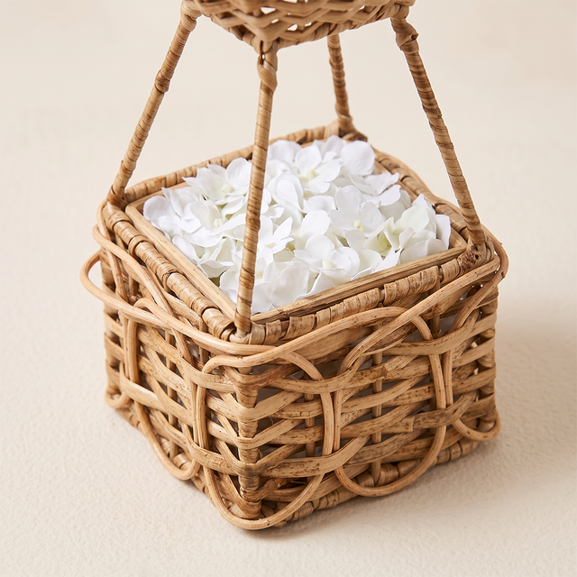 close up of wicker balloon basket with white petals