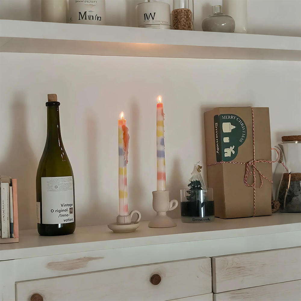 colorful dripping scented candle on the cupboard