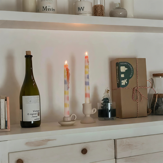 colorful dripping scented candle on the cupboard