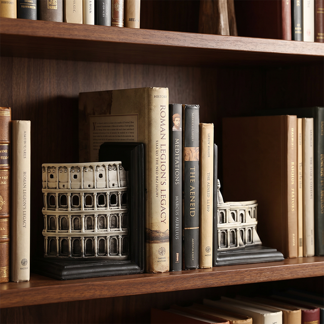 colosseum bookends on dark wooden bookshelf