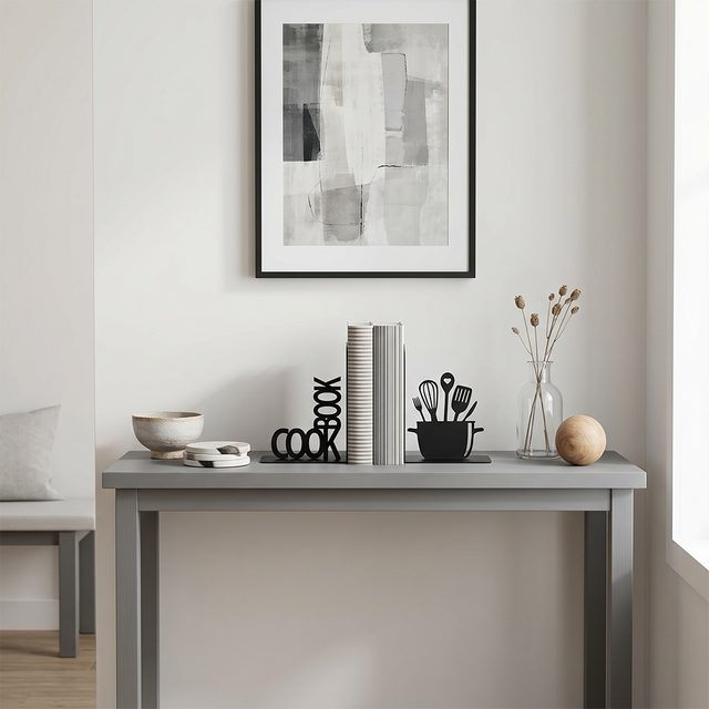 cookbook bookends on grey console under painting