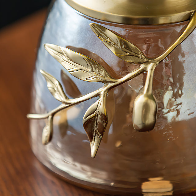 decorative glass brass golden jar with a leaf shaped lid details