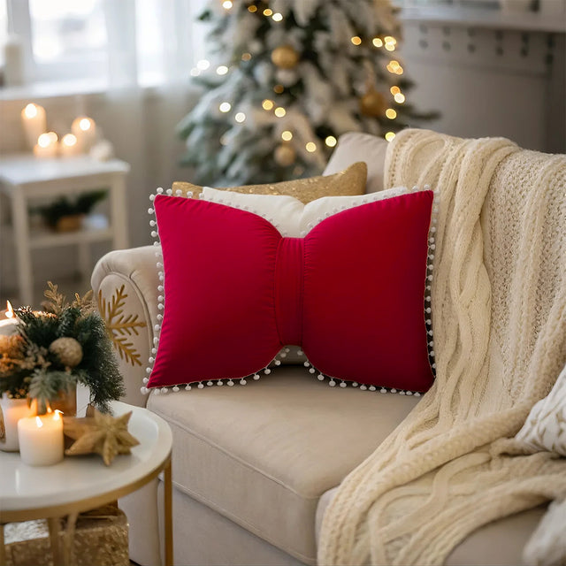 decorative red bow throw pillow on beige sofa