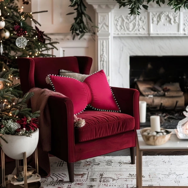 decorative red bow throw pillow on red sofa