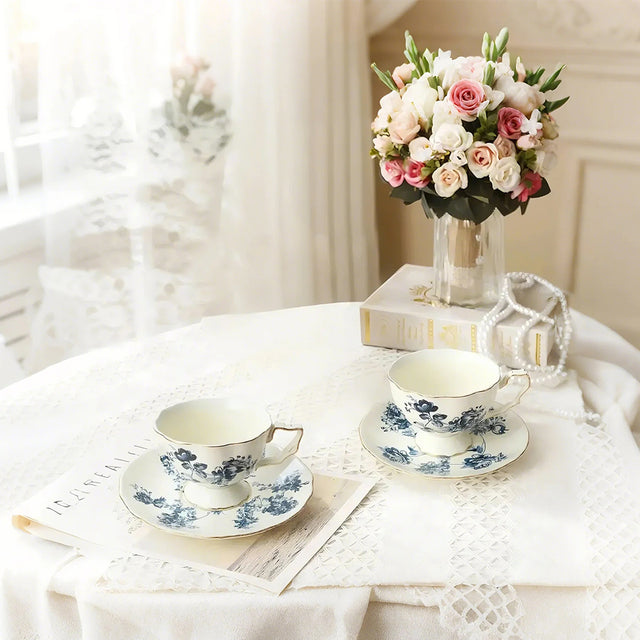 display of two ceramic floral tea sets