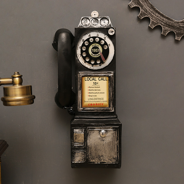 distressed resin decorative desk phone hanging on the wall