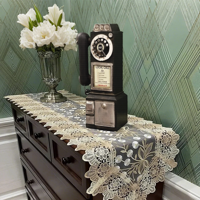 distressed resin decorative desk phone on a table runner
