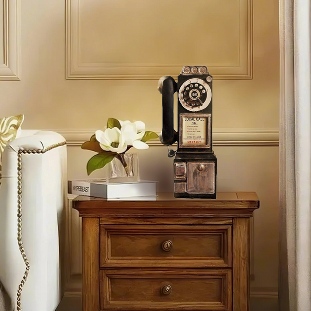 distressed resin decorative desk phone on a wood desk