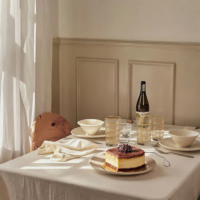 elegant gold rimmed drinking glasses beside cake