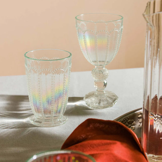 embossed glass iridescent water tumbler and goblet on the table