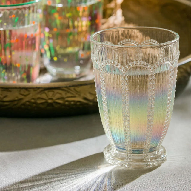 embossed glass iridescent water tumbler on the table