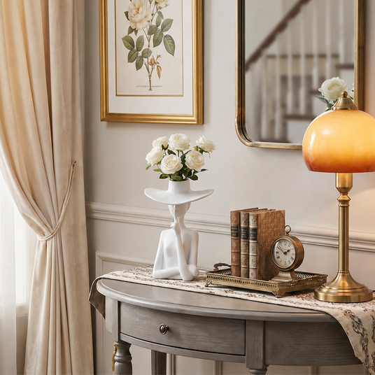 figure vase with roses on console table