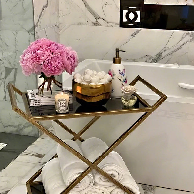 floral ceramic soap dispenser near the tub