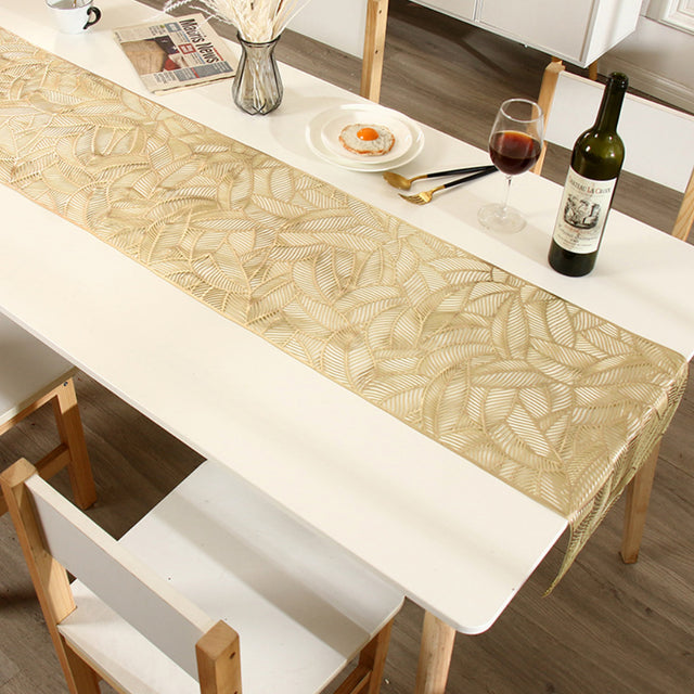 floral lace PVC table runner placed on the white dining table