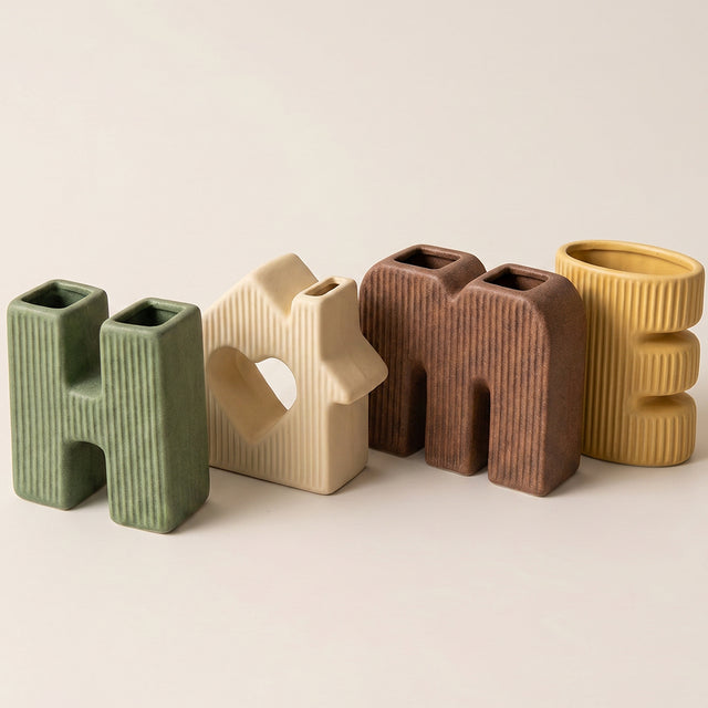 four letter vases standing together closeup