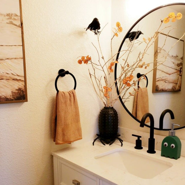 ghost shaped ceramic press-type dispenser bottle on toilet table