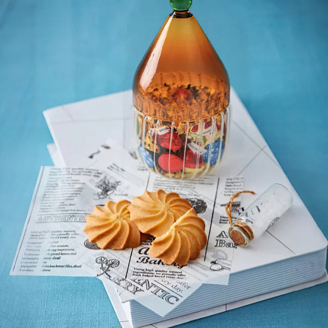 glass christmas hat candy jar with lid on the table