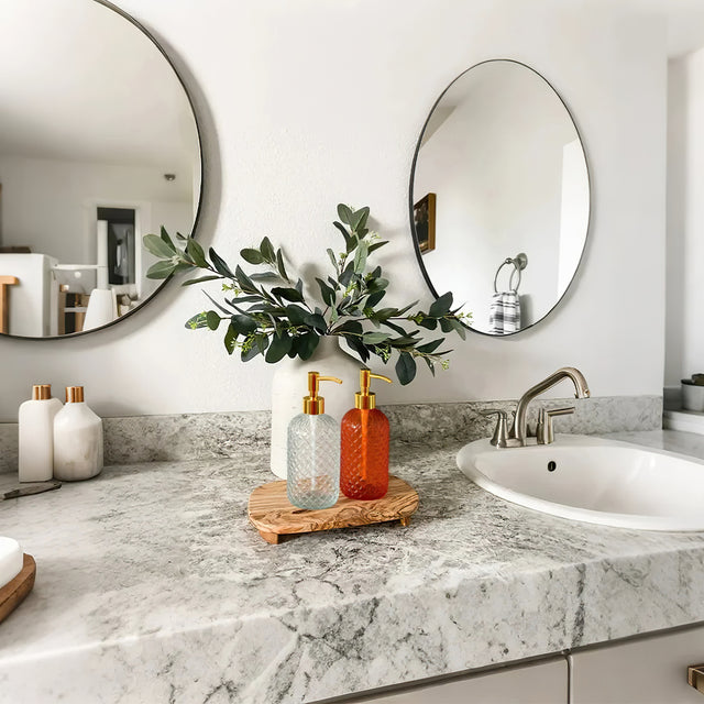 glass dispenser pump bottles on the sink counter