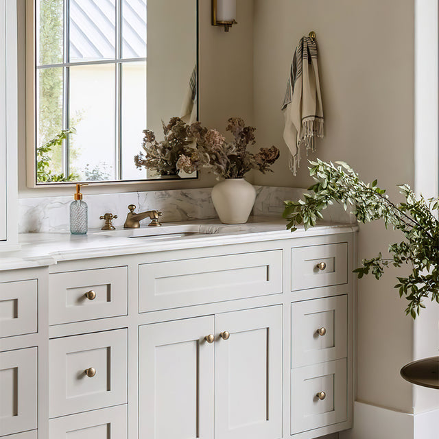 glass dispenser pump clear bottles on the sink counter