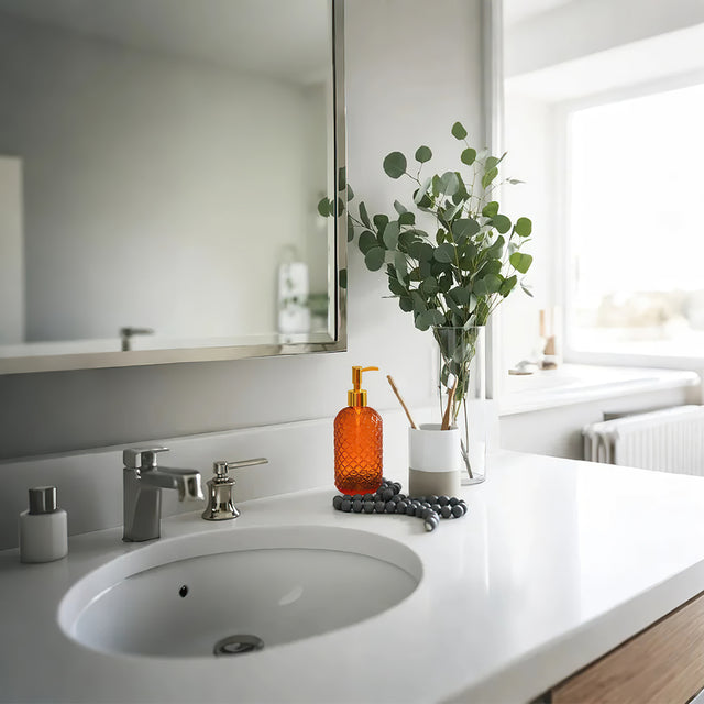 glass dispenser pump orange bottles in the bathroom