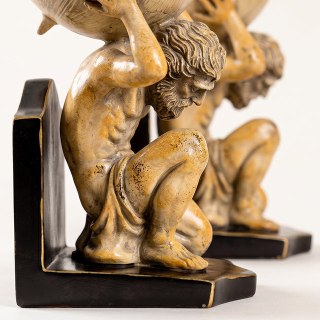 gold cherub statues holding books