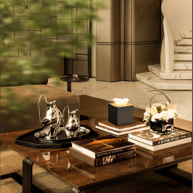 gold lacquer tissue box cover on books