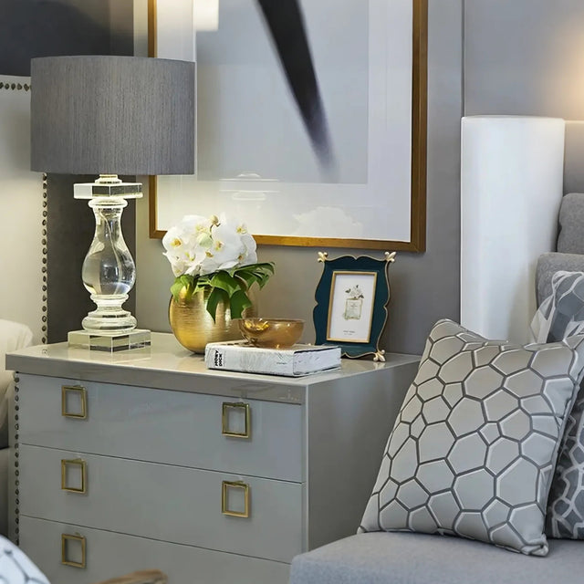 green picture frame on the wood nightstand