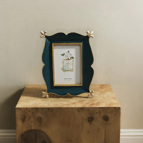 green picture frame on the wood table