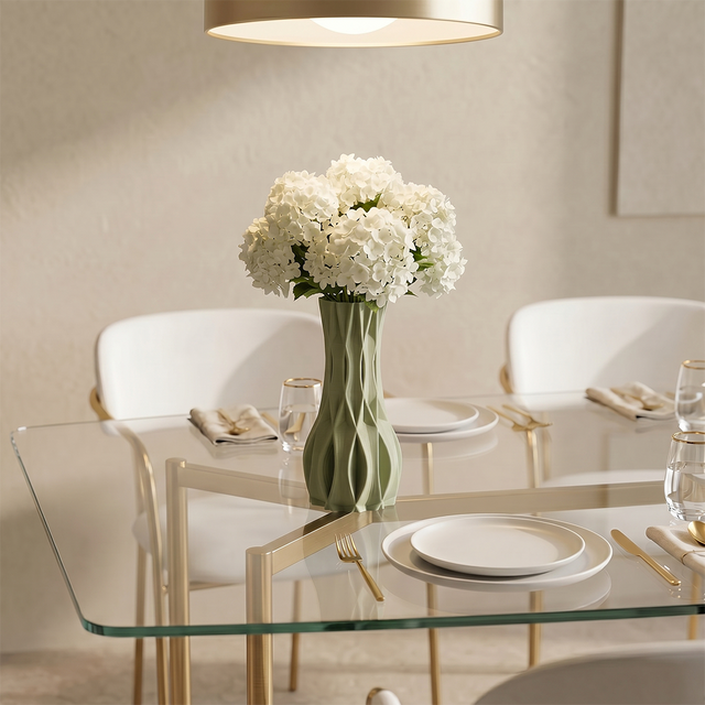 green vase with hydrangeas on glass dining table