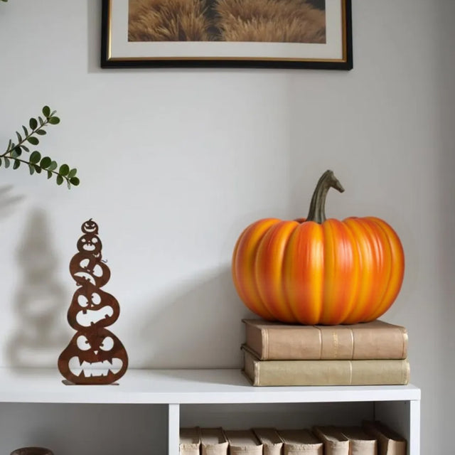 halloween resin pumpkin decor placed on books