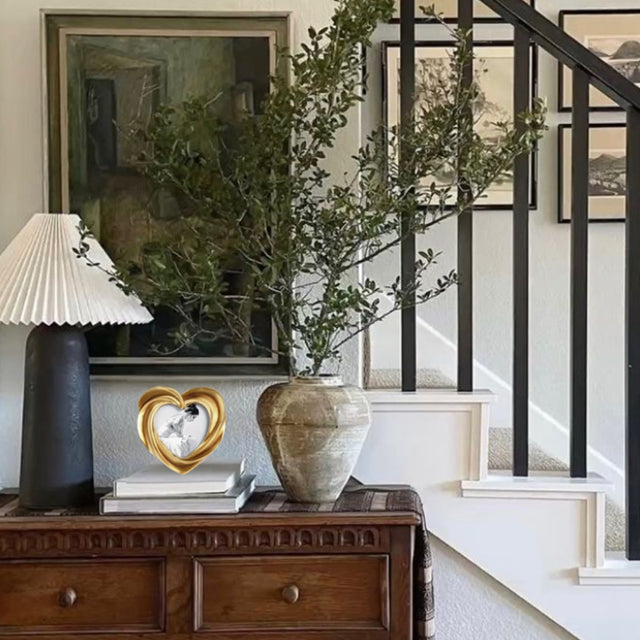 heart-shaped golden decorative picture frame on the table