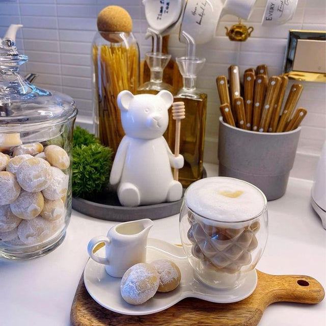 honey jar with stirring rod on the kitchen counter