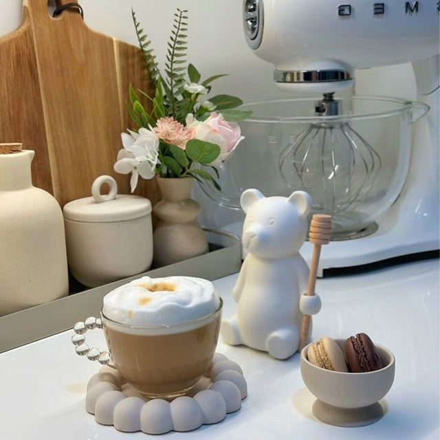 honey jar with stirring rod on the kitchen counter