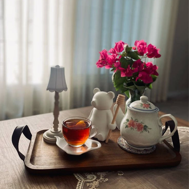 honey jar with stirring rod on the tray