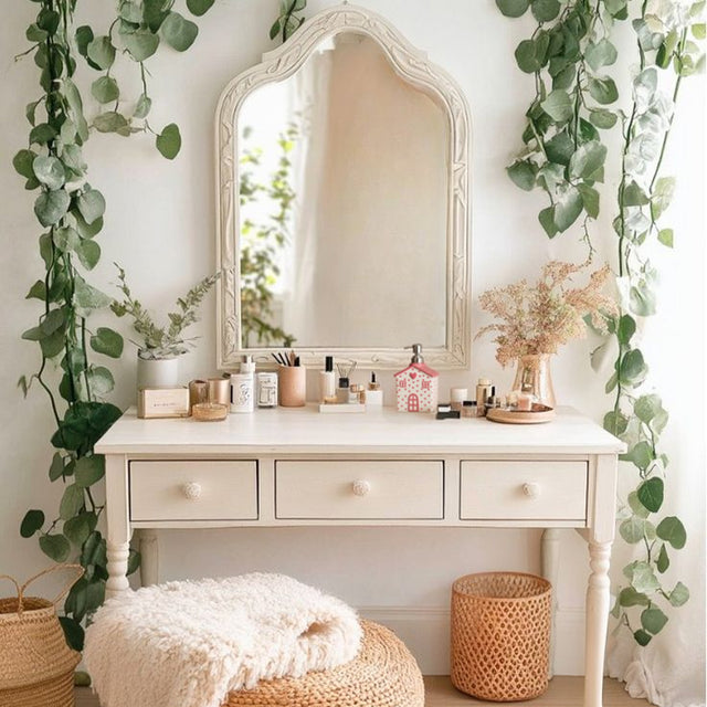 house-shaped pink ceramic soap dispenser near the mirror