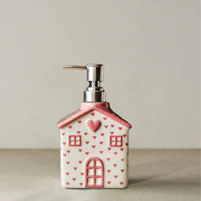 house-shaped pink ceramic soap dispenser