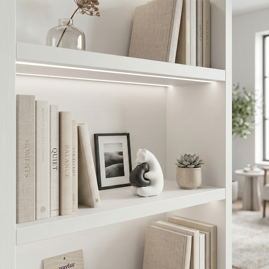hugging bear figurine on white shelf with books