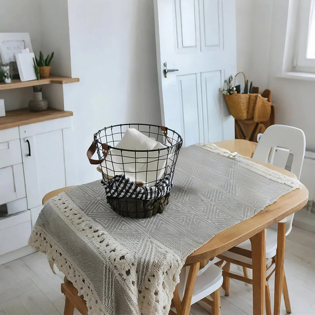 iron wire black laundry storage basket with leather handles on the table