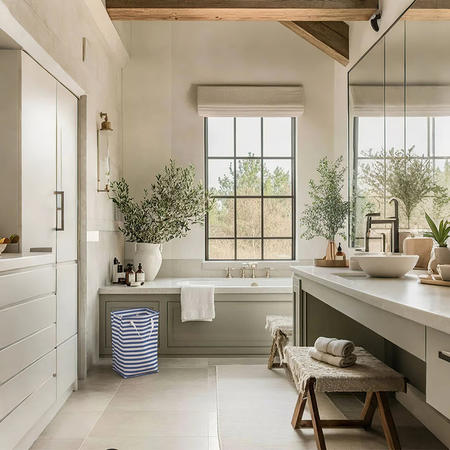 large foldable laundry basket with easy carry handles in the bathroom