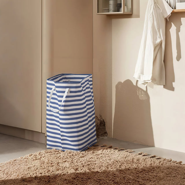 large foldable laundry basket with easy carry handles on the floor